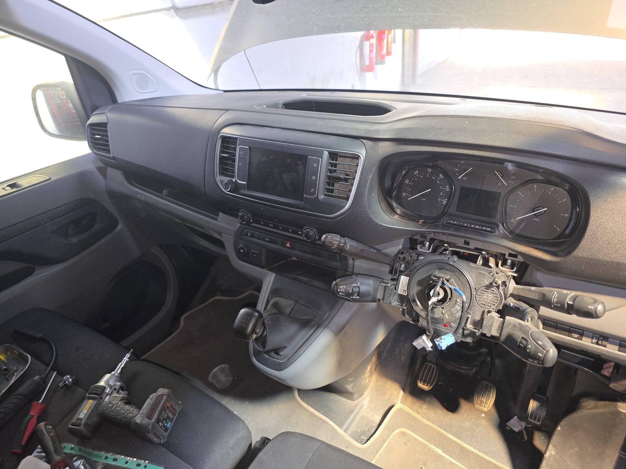 A van cab with the dashboard trim and steering column cover taken off