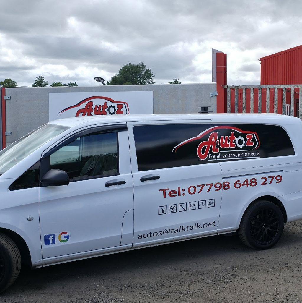 The white Autoz van in full livery with the phone number, email and service icons down the side