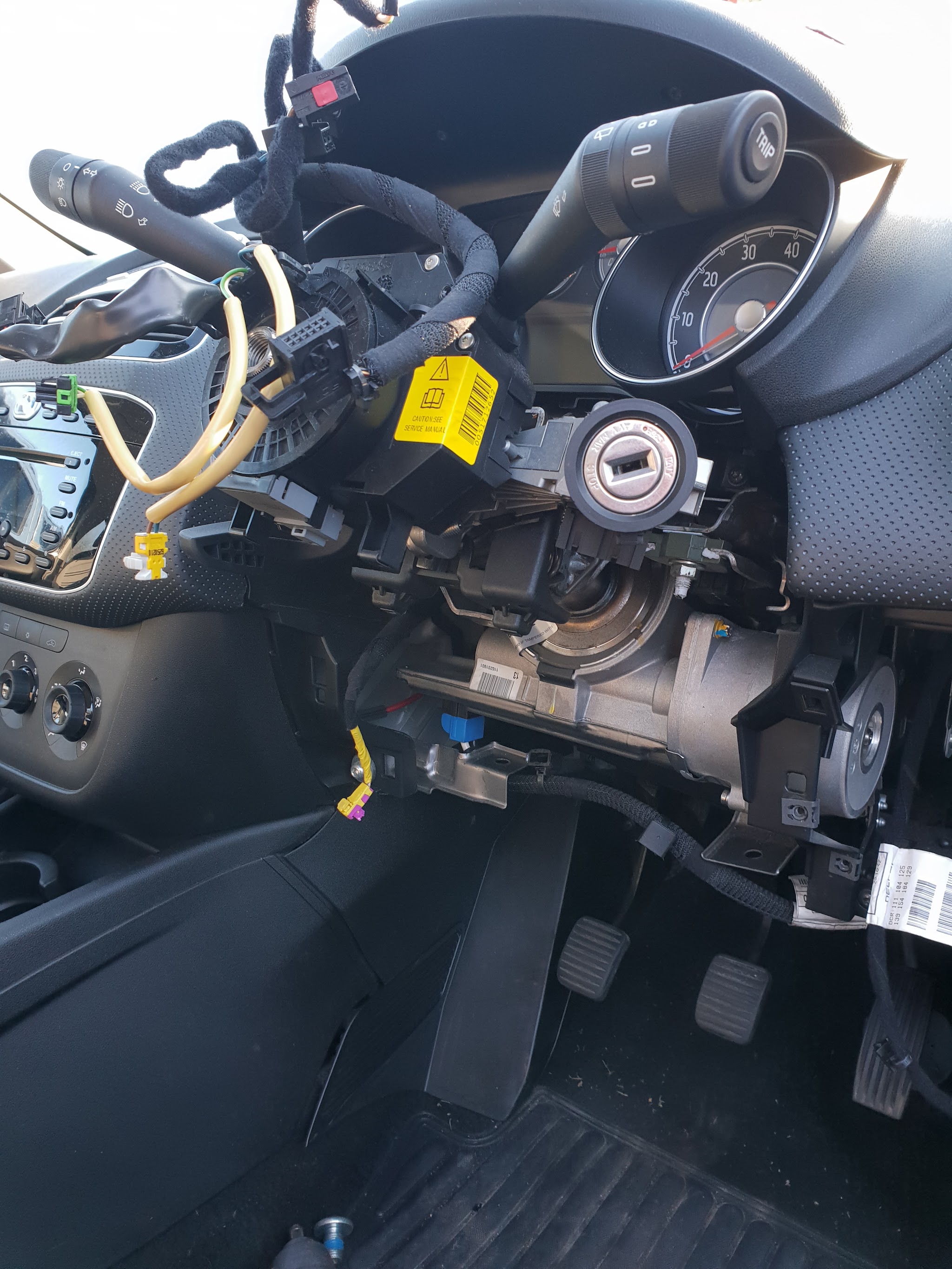 A steering column and dashboard opened up with the wiring exposed